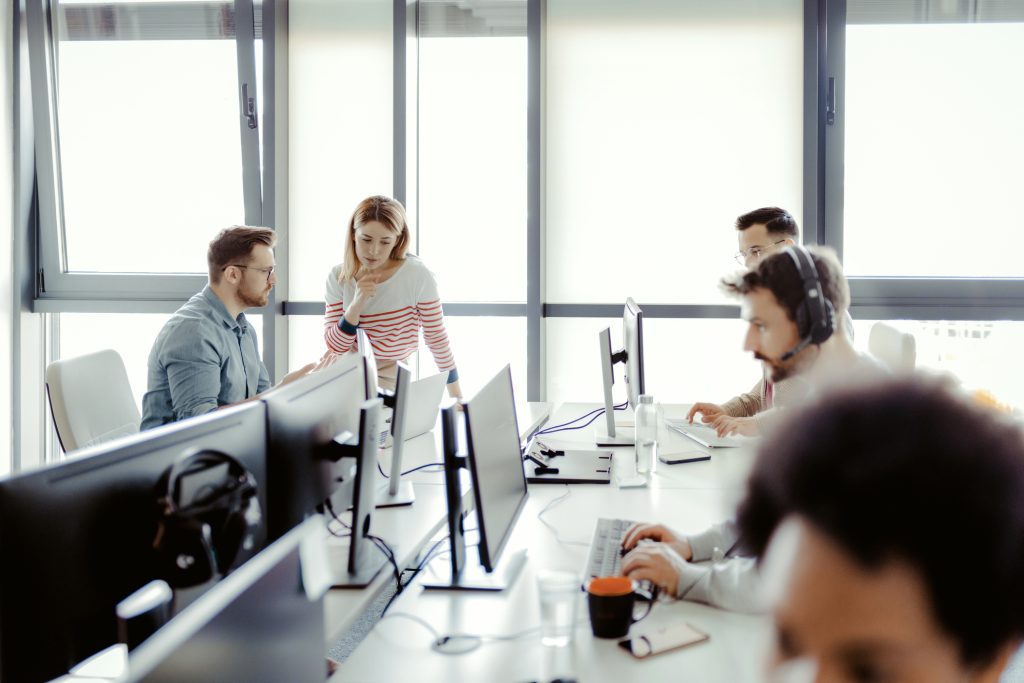 A group of people working on computers in an office.