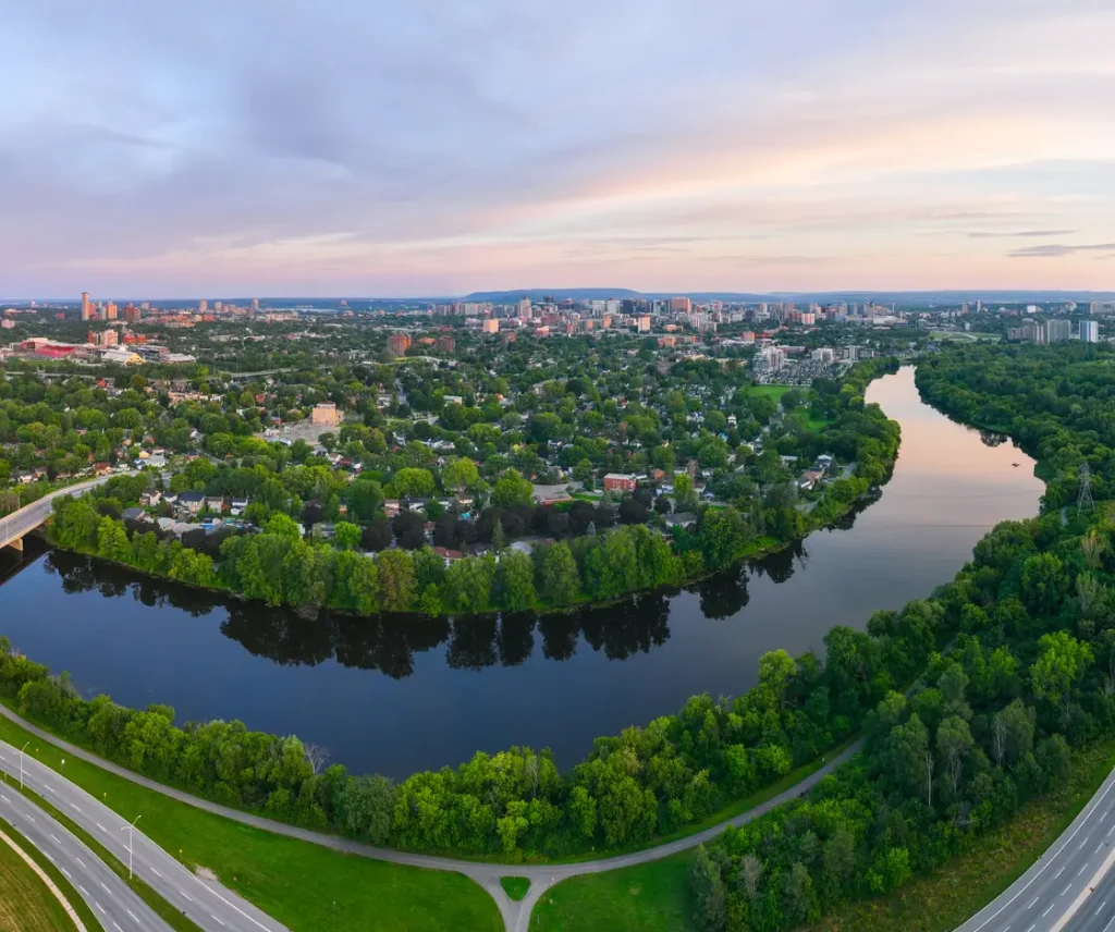 Ottawa skyline as sunrise, over the Rideau river.