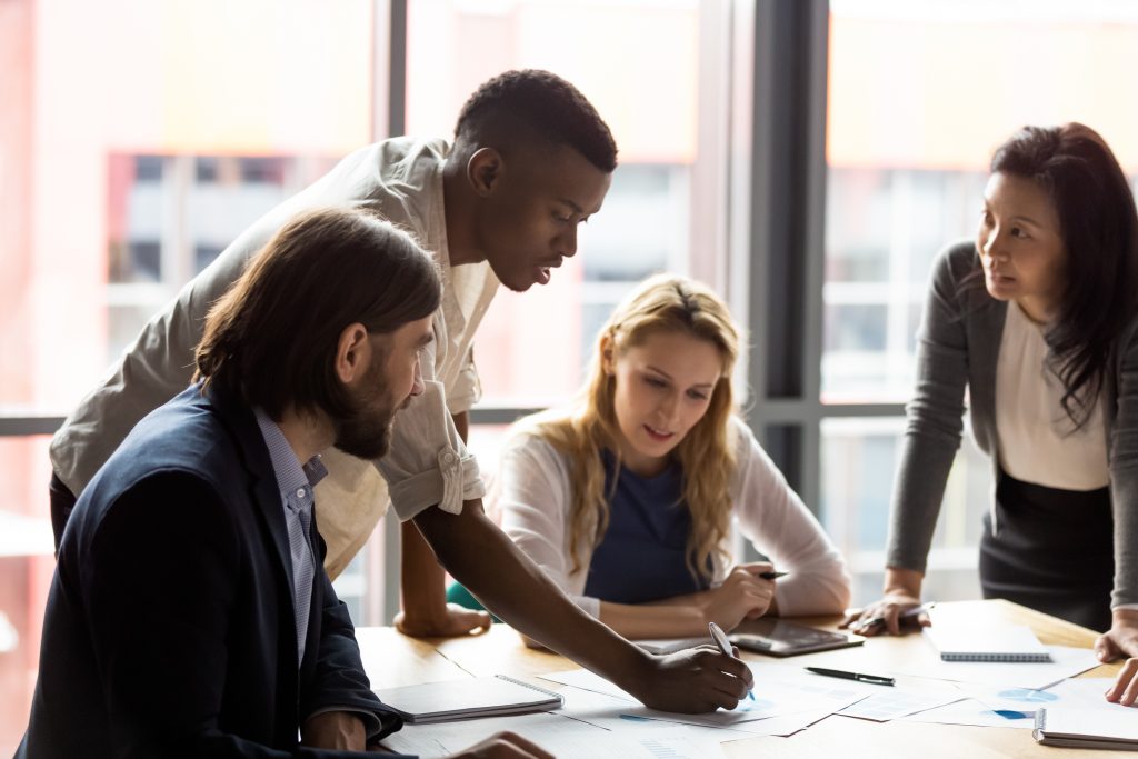 A group of business people sitting around a table.