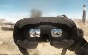 Une personne tenant un casque vr devant un désert.