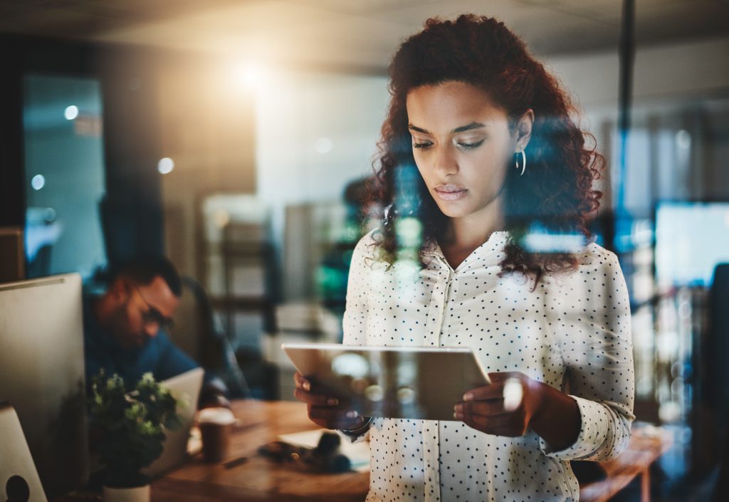 A woman using a tablet in an office.