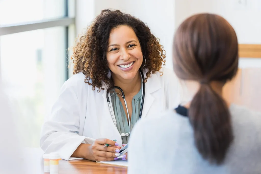 Military family doctor talking to woman