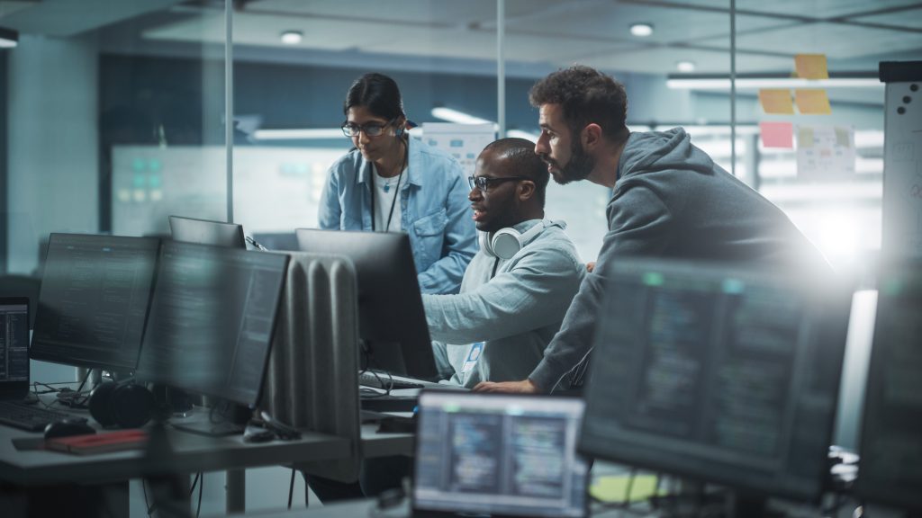 A group of people looking at computers.