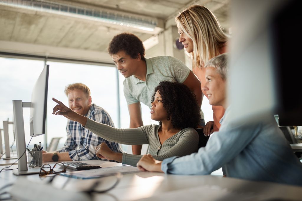 A group of people looking at a computer screen.